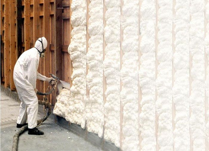 Нанасяне на полиуретанова пяна върху стената на сграда, която ще бъде изолирана